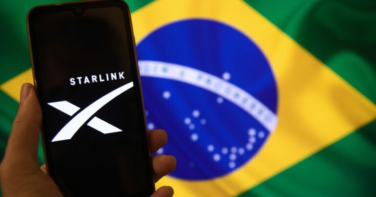 Logo da Starlink exibida em um smartphone à frente da bandeira do Brasil, simbolizando a atuação da empresa no país